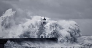 Image of waves crashing against lighthouse