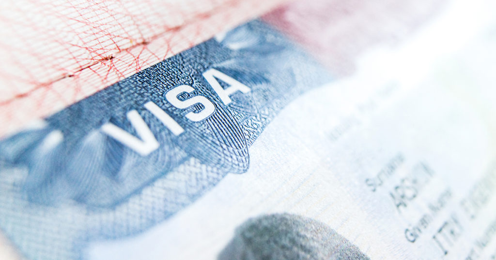 Visa stamp in United States passport with blurry background