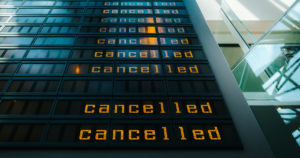Electronic announcement board similar to those in airports and train stations with the word "cancelled" repeated on the right hand side.