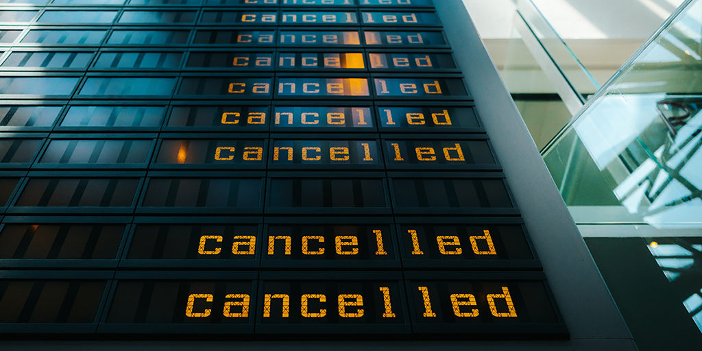 Electronic announcement board similar to those in airports and train stations with the word "cancelled" repeated on the right hand side.